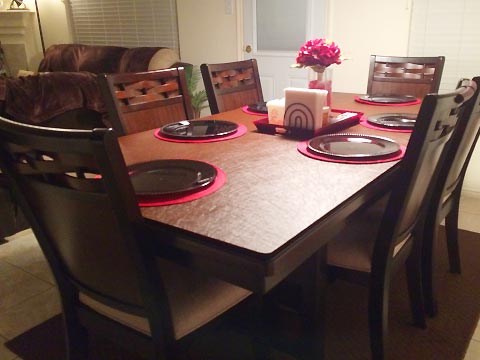 Protective dining table pad with plates and centerpiece