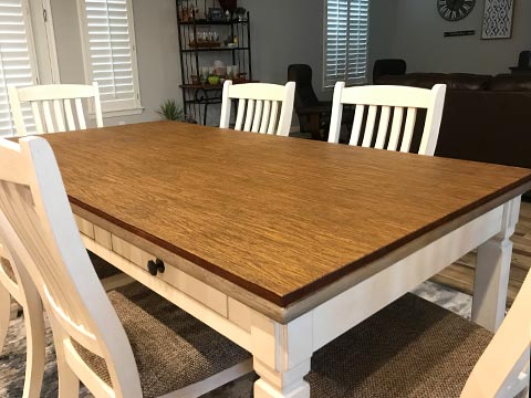 Sharp-cornered rectangle dining table with oak woodgrain protective pad