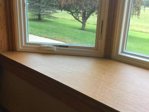 Box window ledge protected by removable pad