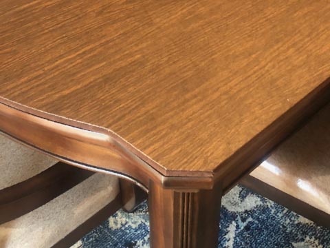 Close-up of table pad with custom scalloped corner