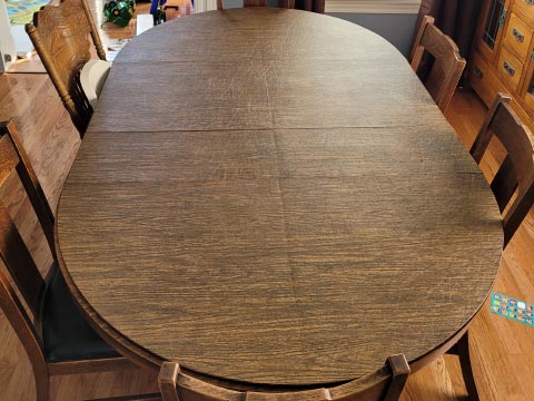 Oval woodgrain table protection pad