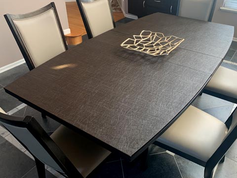 Protective pad for walnut dining table with curved sides