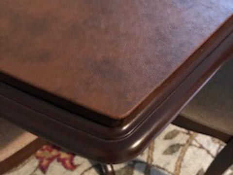Leather-look dining table protector pad, corner close-up